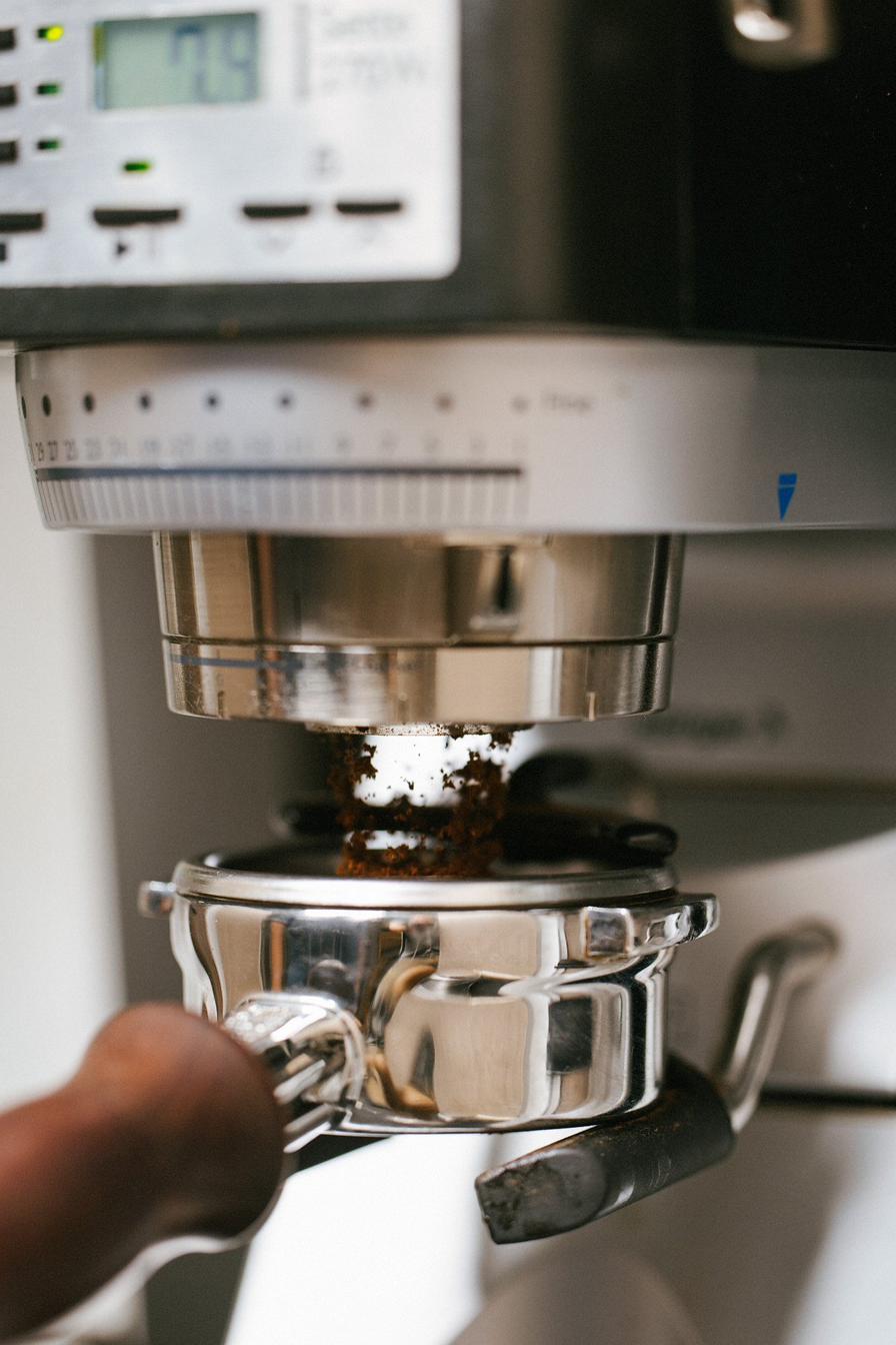 Freshly ground espresso dosing into the portafilter